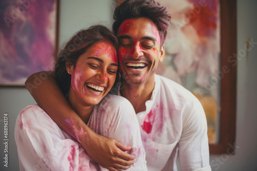 Indian ethnic fun loving couple celebrating Holi festival with colours