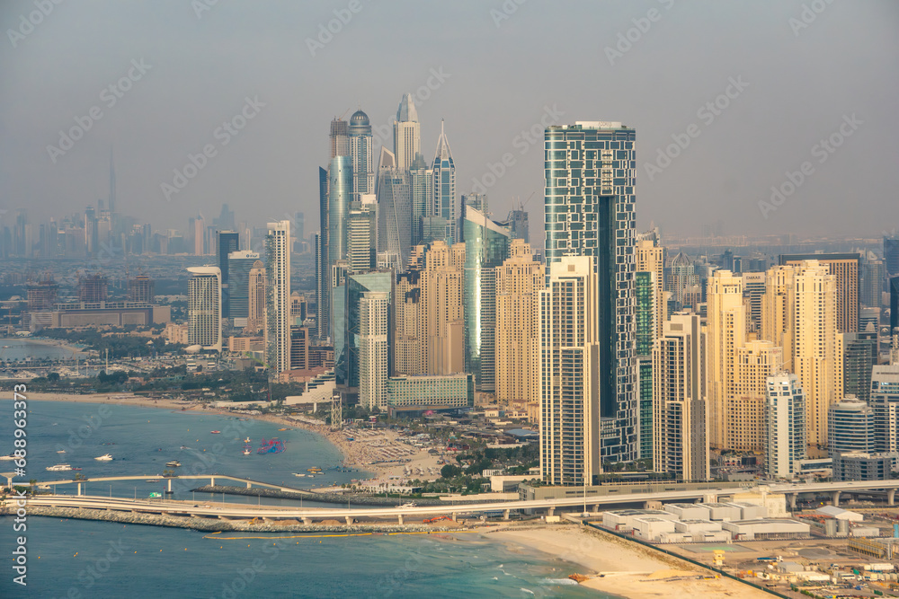 Aerial view of Dubai Marina and the waterfront at dusk, with famous hotels and buildings