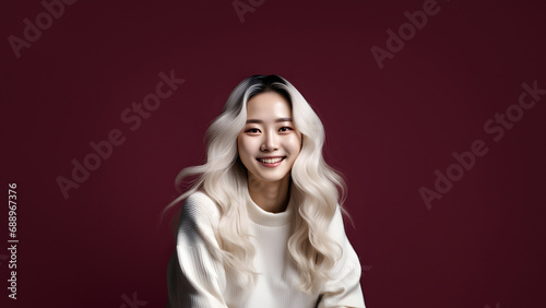 Beautiful young woman smiling isolated on studio background. Copyspace area