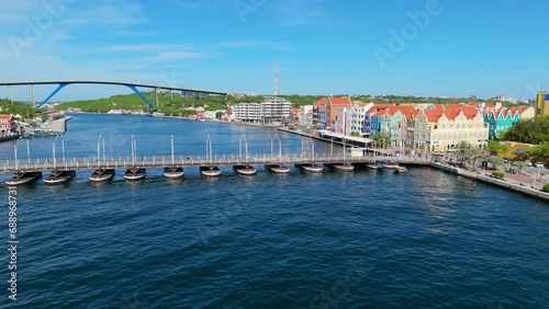 Drone push in to Queen Emma pontoon bridge in Handelskade Punda District Willemstad Curacao with Juliana bridge behind photo