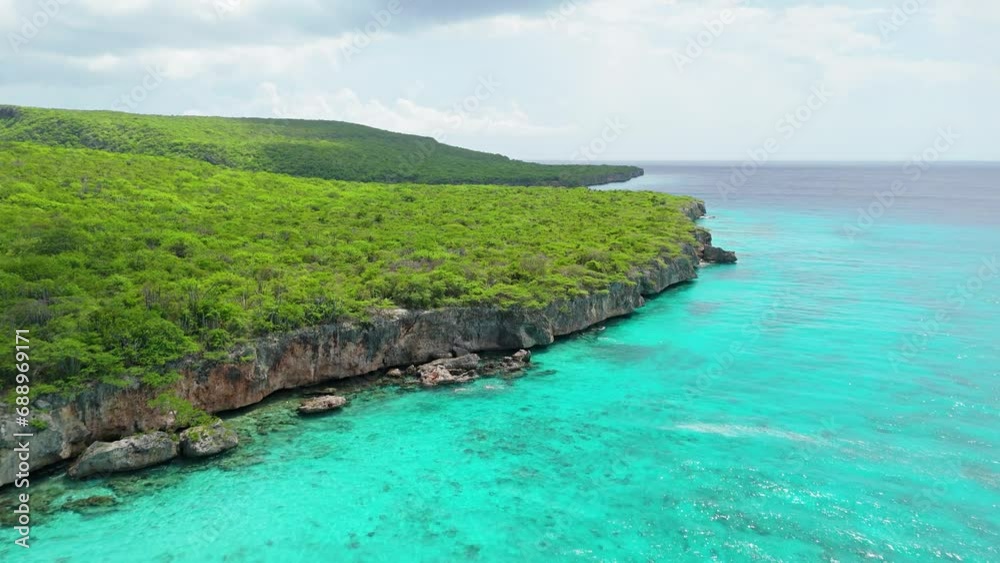 Drone rises showcasing stunning cliffs near Playa Porto Mari in Caribbean island of Curacao Drone rises showcasing stunning cliffs near Playa Porto Mari in Caribbean island of Curacao