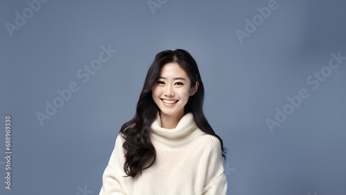 Beautiful young woman smiling isolated on studio background. Copyspace area