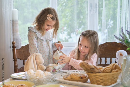 Capturing timeless memories: Young girls in the countryside savoring a classic tea time experience