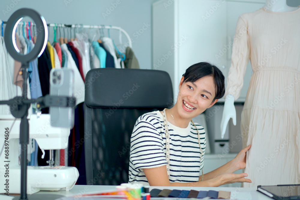 Obraz premium Woman designer presenting her dress designing.