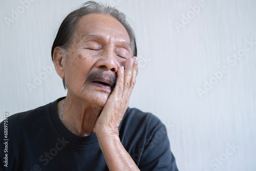 Asian unhappy elder man problems with gum pain studio shot isolated on beige background, Portrait senior old man sad hand touching cheek