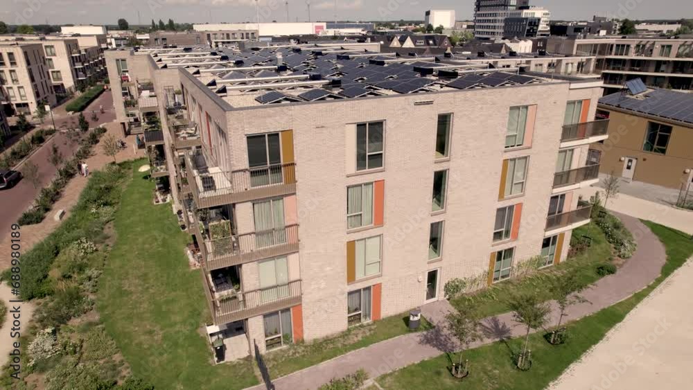 Aerial pan showing exterior facade of social housing collective building Ubuntuplein project in Zutphen, The Netherlands. Dutch engineering real estate investment urban planning Aerial pan showing exterior facade of social housing collective building Ubuntuplein project in Zutphen, The Netherlands. Dutch engineering real estate investment urban planning