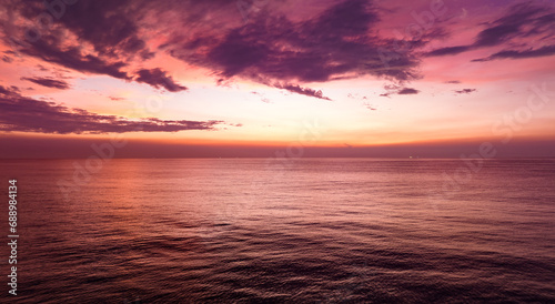 Amazing sunset or sunrise sky over sea landscape,Beautiful colorful light of nature seascape background,Drone aerial view ocean background © panya99