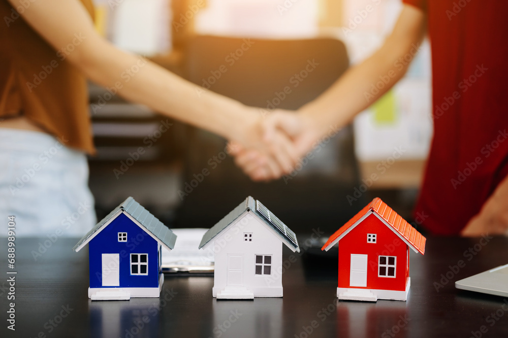 balancing the property sector The real estate agent is explaining the house style to see the house design and the purchase agreement. model balancing the property sector The real estate agent is explaining the house style to see the house design and the purchase agreement. model