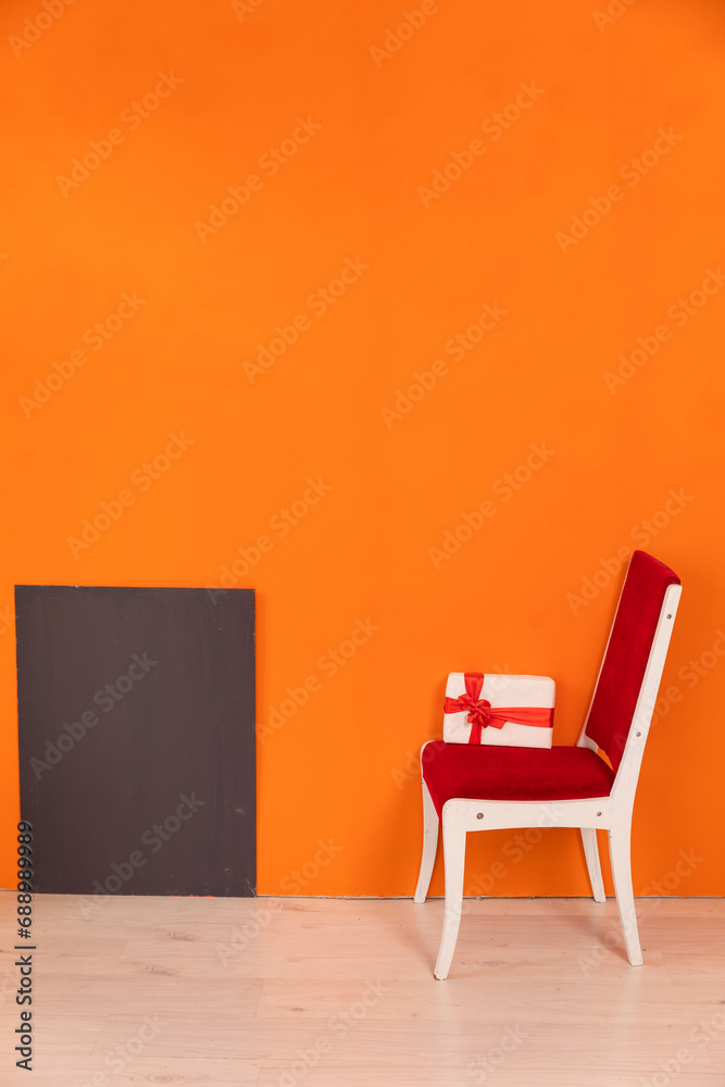 One Chair With Holiday Gift Against Bright Colored Wall