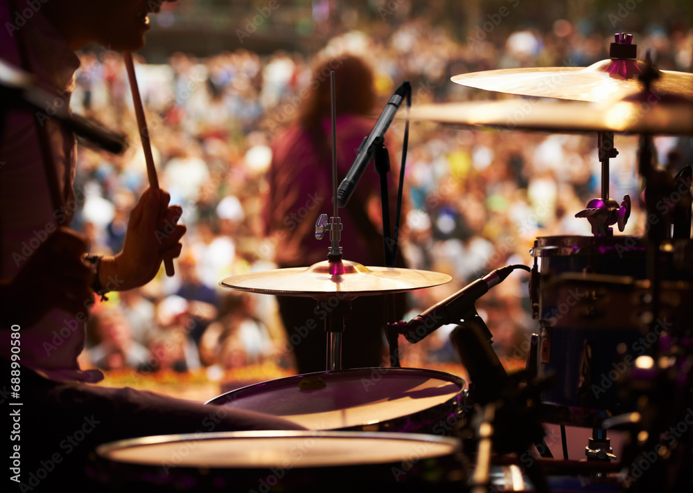 Naklejka premium Drums, playing and closeup of hands, concert and music festival in outdoors, talent and audience. Band, performance and entertainment for crowd, instrument and rhythm for people, sound and rock