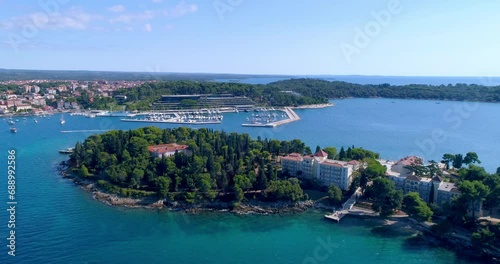 Rovinj, Croatia aerial push-in shot flying south over Katerina island towards hotel Marina photo
