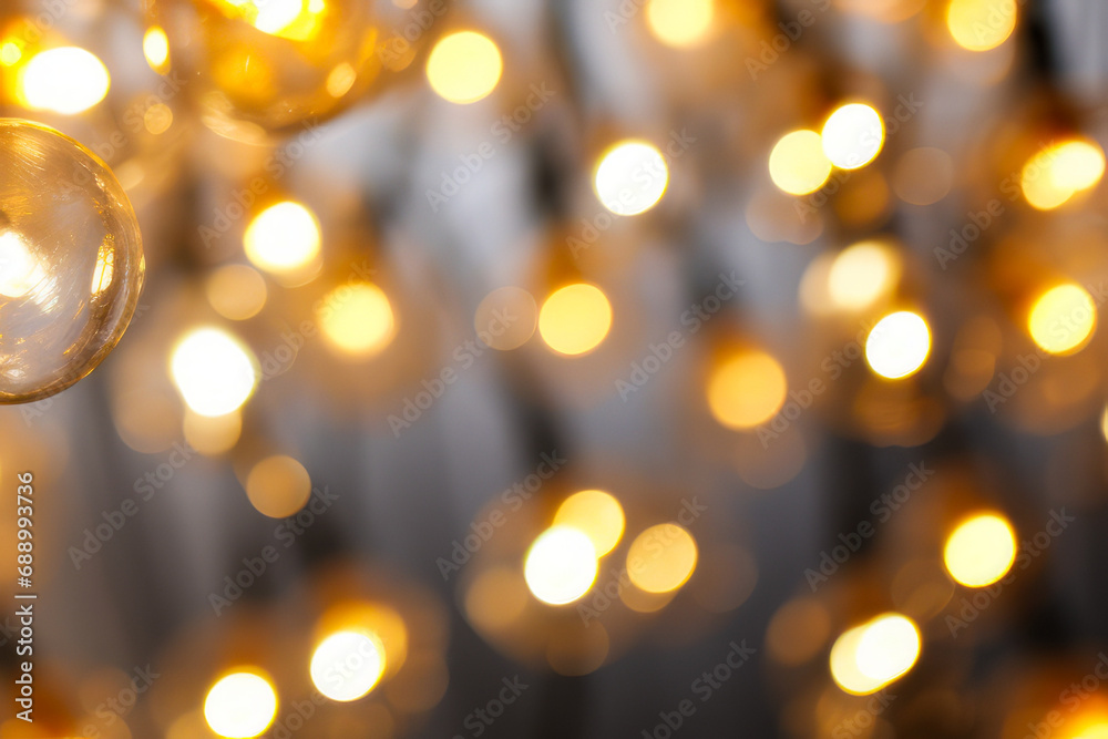 Close up of bunch of lights on wall with blurry background.