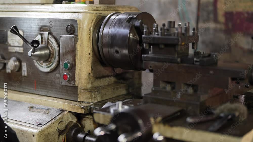 close up of machine operation for Metal Lathes. The steel column rolling in machine. metalworking industry. finishing metal working internal steel surface on lathe grinder machine with flying sparks close up of machine operation for Metal Lathes. The steel column rolling in machine. metalworking industry. finishing metal working internal steel surface on lathe grinder machine with flying sparks