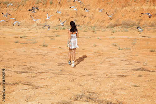 A woman runs to the birds on a walk