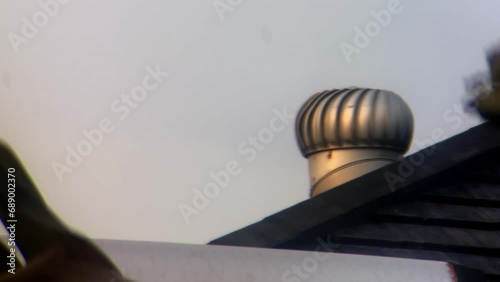 industrial single roof ventilator spinning in 4k still zoom footage background
