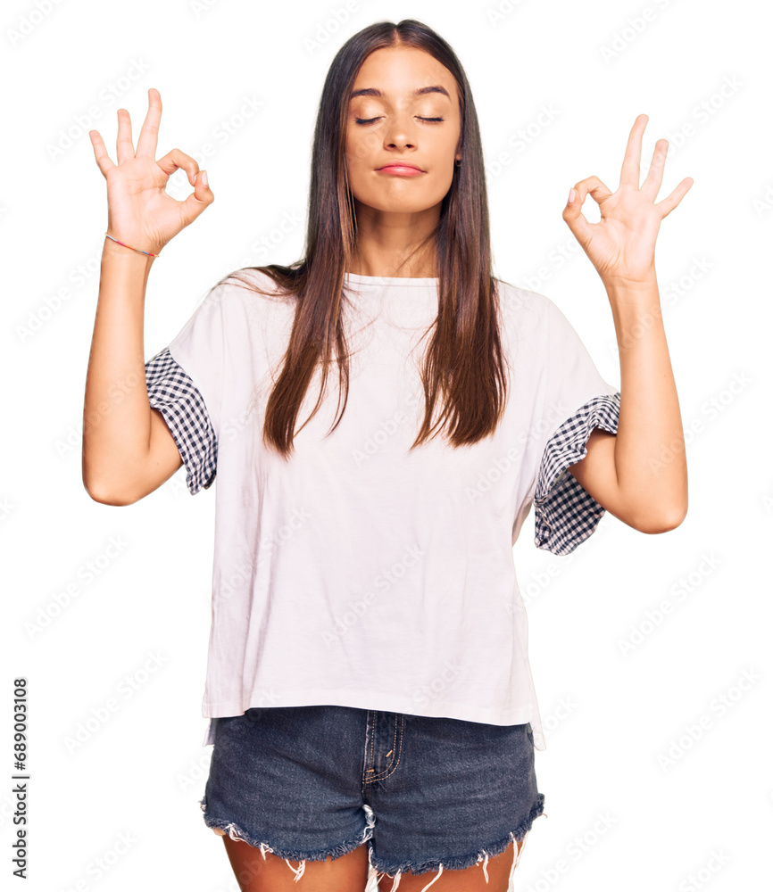 Young hispanic woman wearing casual clothes relax and smiling with eyes closed doing meditation gesture with fingers. yoga concept. Young hispanic woman wearing casual clothes relax and smiling with eyes closed doing meditation gesture with fingers. yoga concept.
