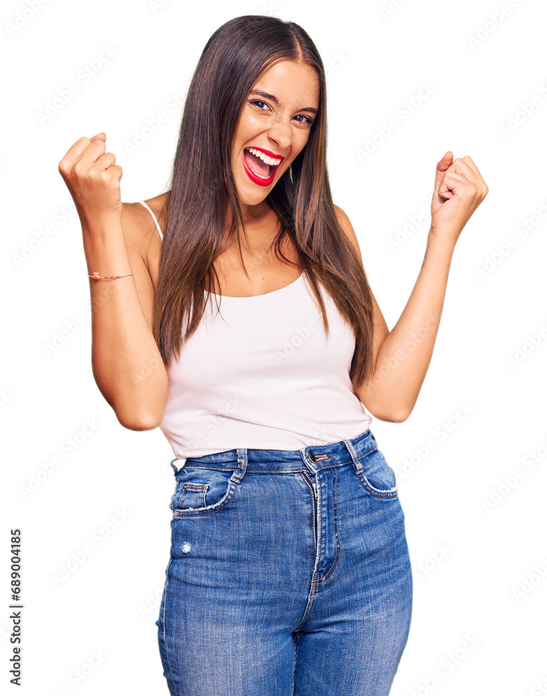 Young hispanic woman wearing casual clothes screaming proud, celebrating victory and success very excited with raised arms Young hispanic woman wearing casual clothes screaming proud, celebrating victory and success very excited with raised arms