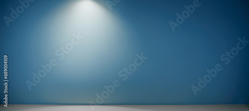 Illuminated Light Hanging Against blue Wall. hanged ceiling lamp warm tone light color bulb light with dark blue tone concrete background wall photo