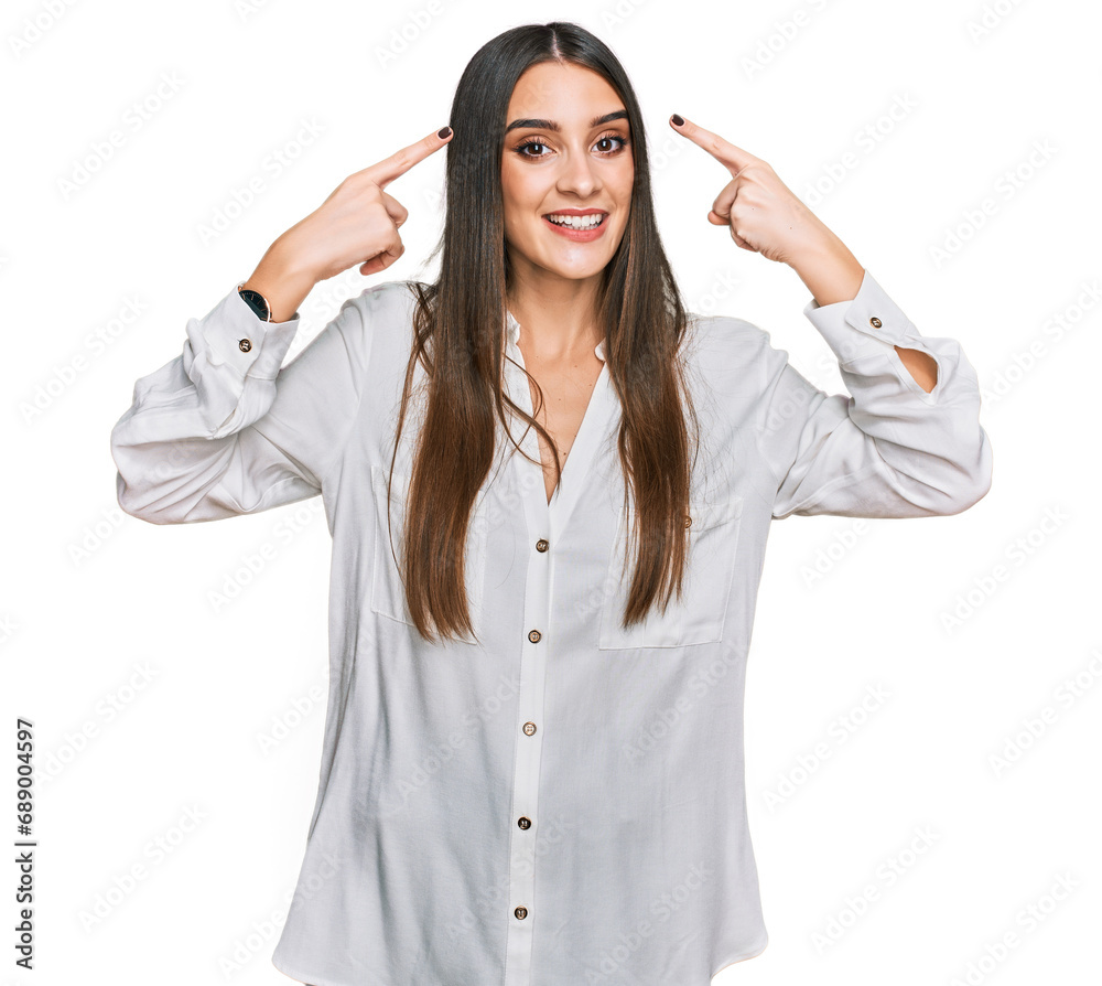 Young beautiful woman wearing casual white shirt smiling pointing to head with both hands finger, great idea or thought, good memory