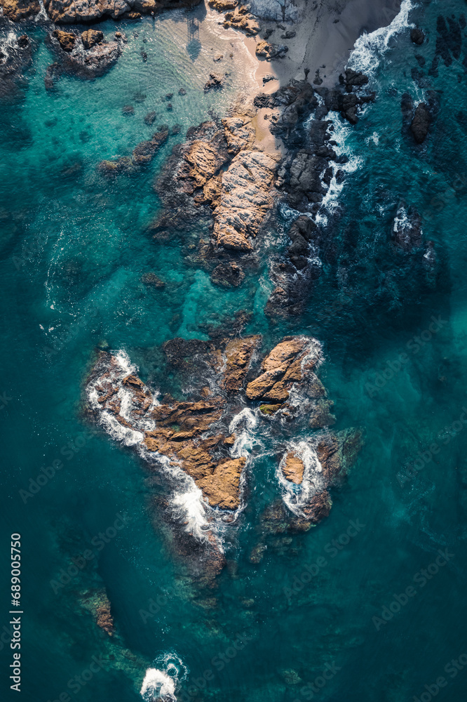 aerial view of rocks in the ocean