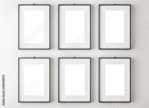 Set of six Blank white photo mockup frame template. Six thin A4 frames with portrait orientation. Mockup of six A4 thin black frames with vertical orientation on light wall.