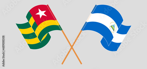 Crossed and waving flags of Togo and Nicaragua