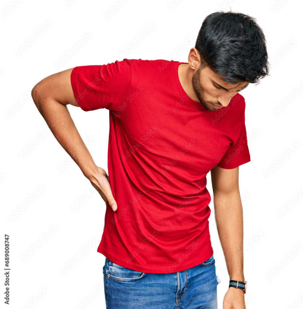 Young handsome man wearing casual red tshirt suffering of backache, touching back with hand, muscular pain Young handsome man wearing casual red tshirt suffering of backache, touching back with hand, muscular pain