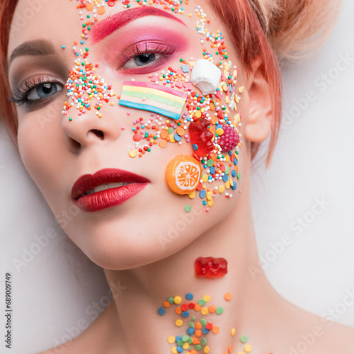 Female with sweets and caramel on her face shot photo