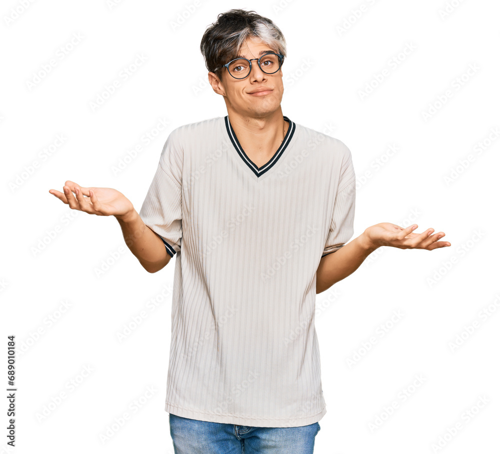 Young hispanic man wearing casual clothes and glasses clueless and confused expression with arms and hands raised. doubt concept. Young hispanic man wearing casual clothes and glasses clueless and confused expression with arms and hands raised. doubt concept.