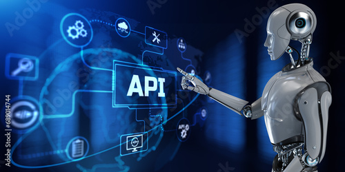 API Application programming interface apps and web development instrument concept. Robot hand pressing button on screen 3d render.