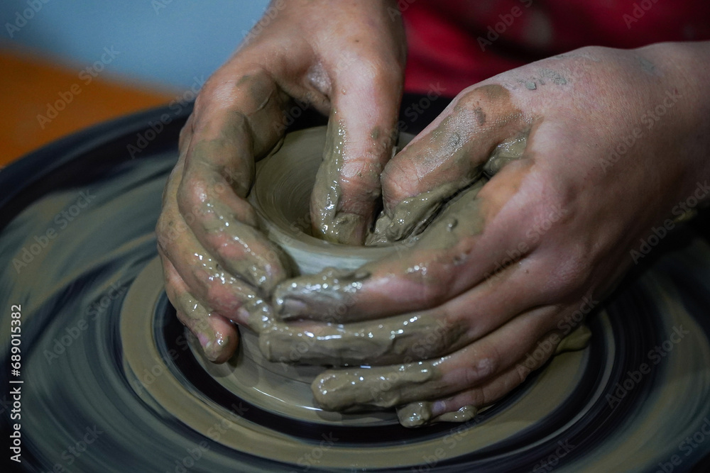 Pottery. The oldest trade from Daco-Roman times. Hands dirty with clay. Ceramics. Modeling in clay. Color and black-and-white detail photos.