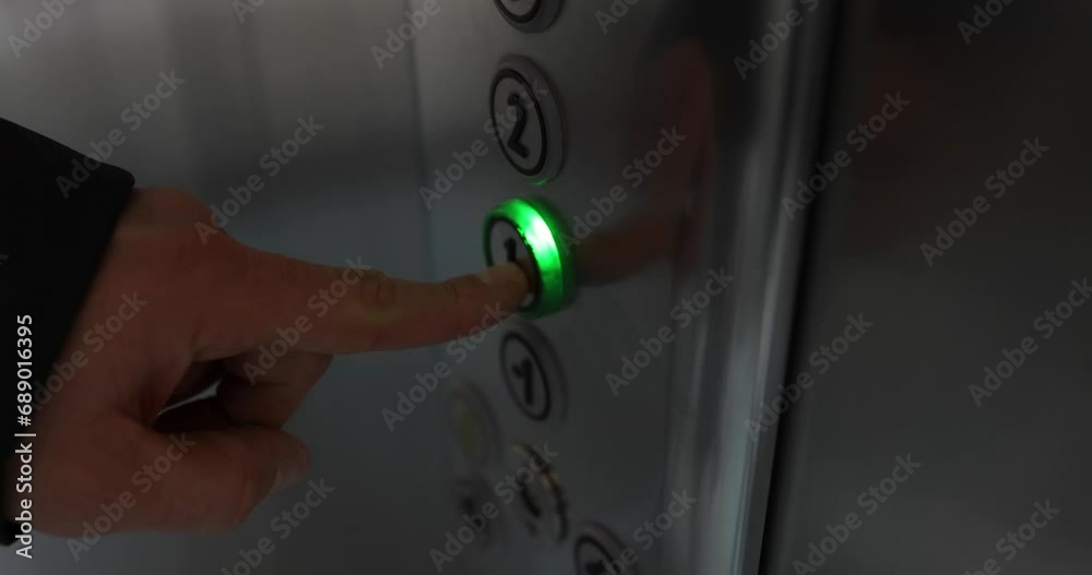 Man hand presses number one in elevator. Use of elevator concept Man hand presses number one in elevator. Use of elevator concept
