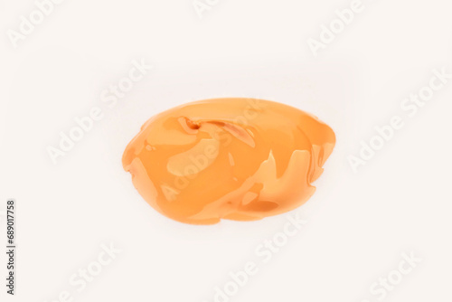 Paint biege spot, isolated on white background. Glossy akril paint. Abstract trace shape. Drops of paint.