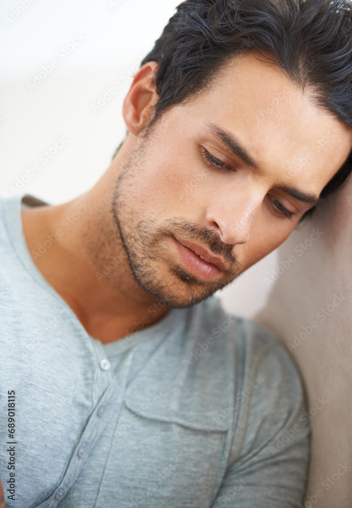 Obraz premium Thinking, depression and sad man in a house with mistake, guilt or grieving, crisis or anxiety. Overthinking, face and male person at home with regret, mourning or broken heart, crisis or disaster