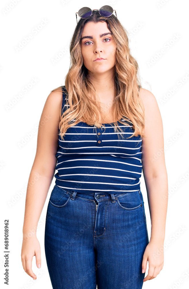 Young caucasian woman wearing casual clothes and sunglasses with serious expression on face. simple and natural looking at the camera. Young caucasian woman wearing casual clothes and sunglasses with serious expression on face. simple and natural looking at the camera.