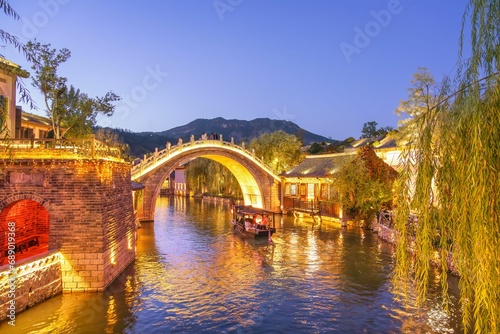 Beautiful bridge and river in the ancient Chinese village of Gubei Water Town with reflections in water at blue hour, Gubeikou, Miyun, Simatai, Beijing, China photo