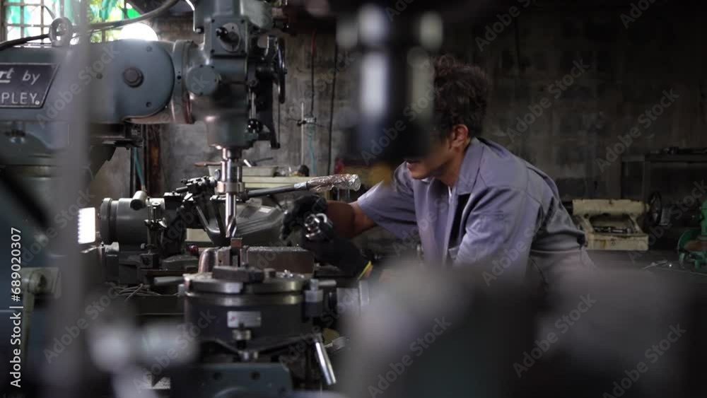 Asian worker in production plant drilling at machine. Professional worker near drilling machine on factory. finishing metal working internal steel surface on lathe grinder machine with flying sparks. Asian worker in production plant drilling at machine. Professional worker near drilling machine on factory. finishing metal working internal steel surface on lathe grinder machine with flying sparks.