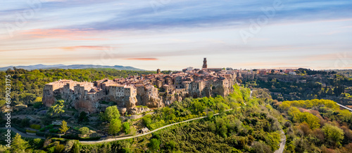 Panoramic aerial view of Pitigliano town in Tuscany, Italy. Typical etruscan town with the houses on the border of the tuff rocks.