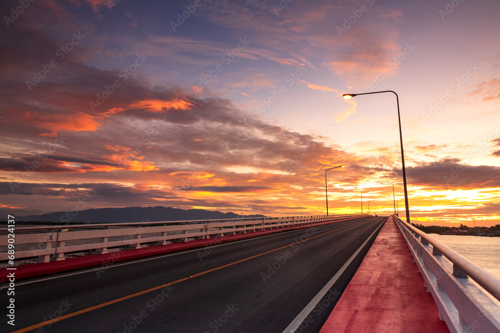 View beautiful of Bridge crossing the sea with dramatic sunrise sky. It is a approximately 1 km long bridge on Taksin Maharat Bridge in Chanthaburi Province of Eastern Thailand. View beautiful of Bridge crossing the sea with dramatic sunrise sky. It is a approximately 1 km long bridge on Taksin Maharat Bridge in Chanthaburi Province of Eastern Thailand.