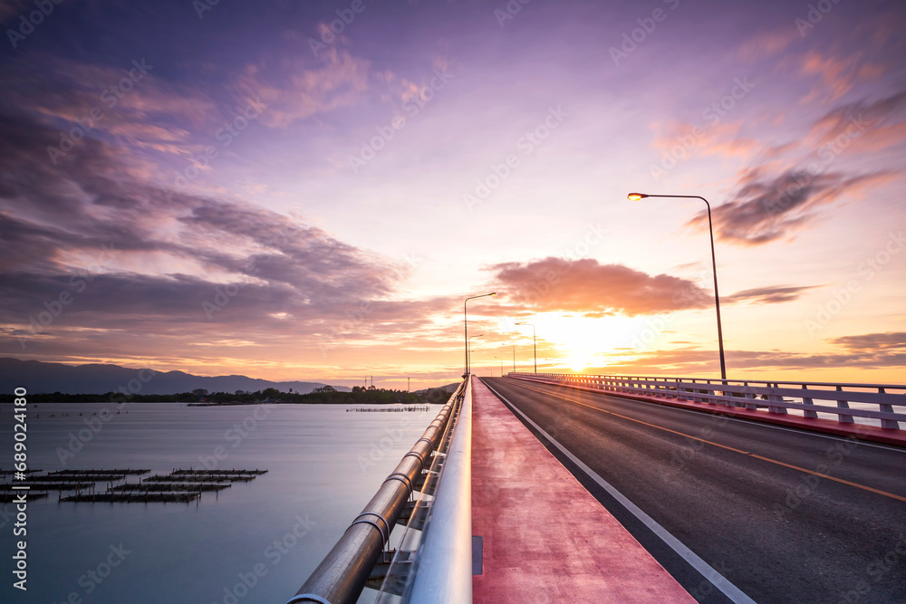 View beautiful of Bridge crossing the sea with dramatic sunrise sky. It is a approximately 1 km long bridge on Taksin Maharat Bridge in Chanthaburi Province of Eastern Thailand.