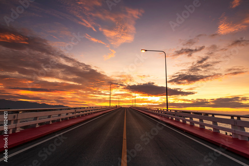 View beautiful of Bridge crossing the sea with dramatic sunrise sky. It is a approximately 1 km long bridge on Taksin Maharat Bridge in Chanthaburi Province of Eastern Thailand. photo