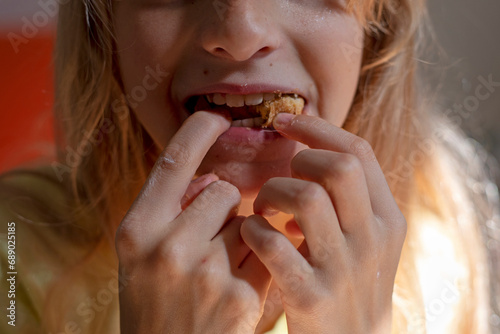 girl eats croissant stuffing it into her mouth © Nataliia Makarovska