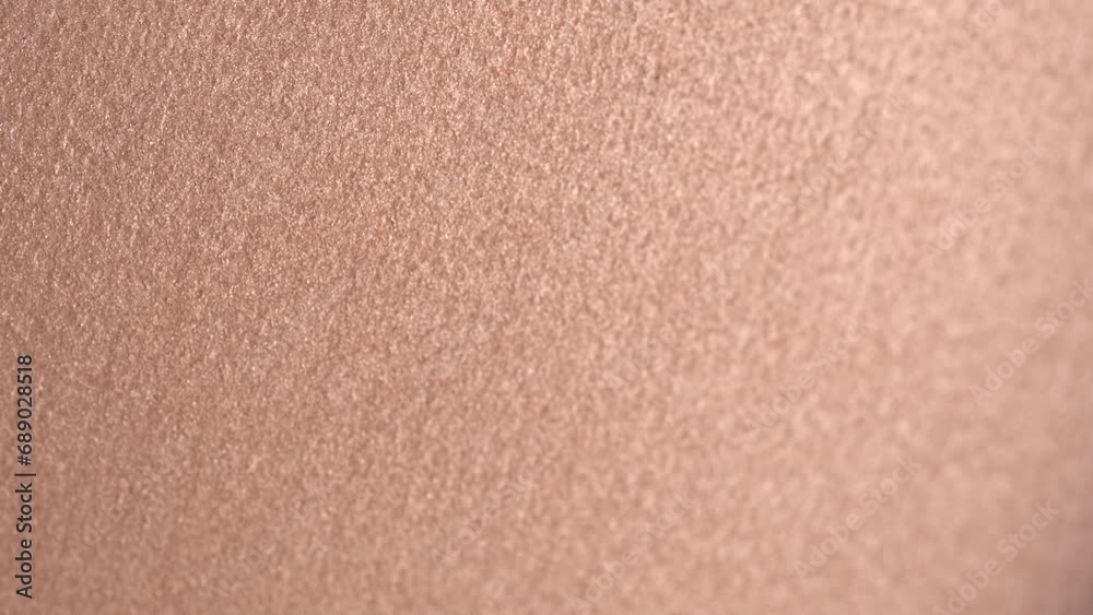 Professional shiny beige eyeshadow, macro. Professional bronzer or highlighter texture, make-up  background, close-up, rotation. Bright brown eye shadows. Cosmetics backdrop. 4K