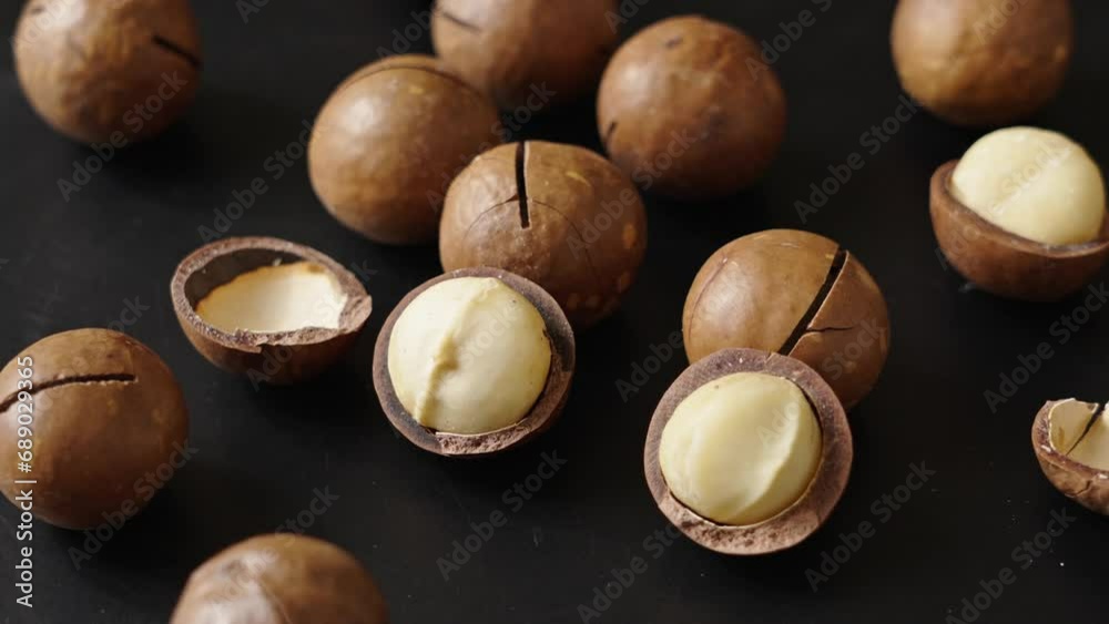 Close up macadamia nuts on black background.