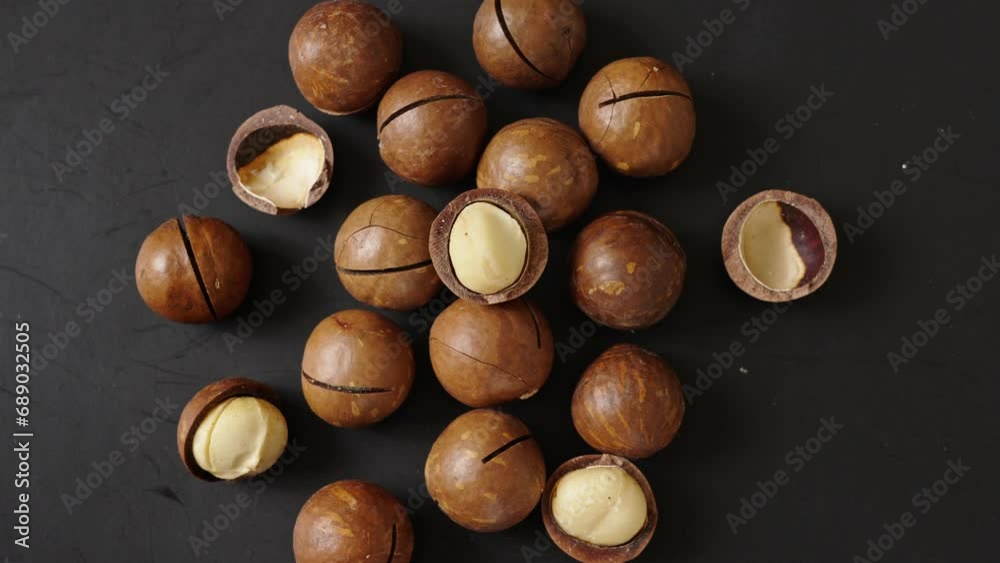Close up macadamia nuts on black background.