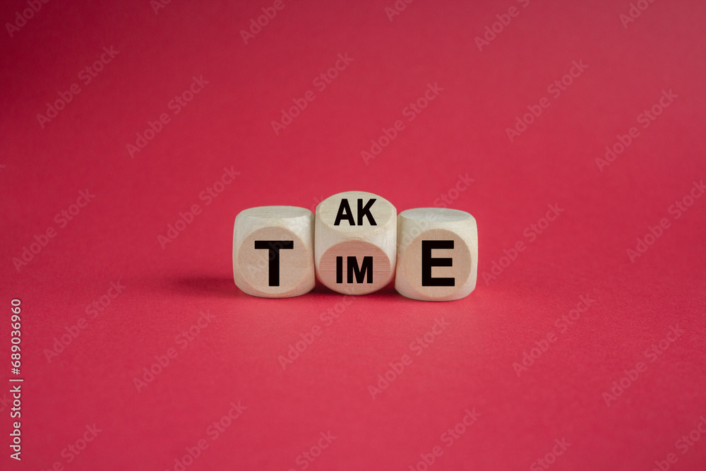 Take your time symbol. Concept word Take Time on wooden cubes. Beautiful red table red background. Business and Take your time concept. Copy space. Take your time symbol. Concept word Take Time on wooden cubes. Beautiful red table red background. Business and Take your time concept. Copy space.