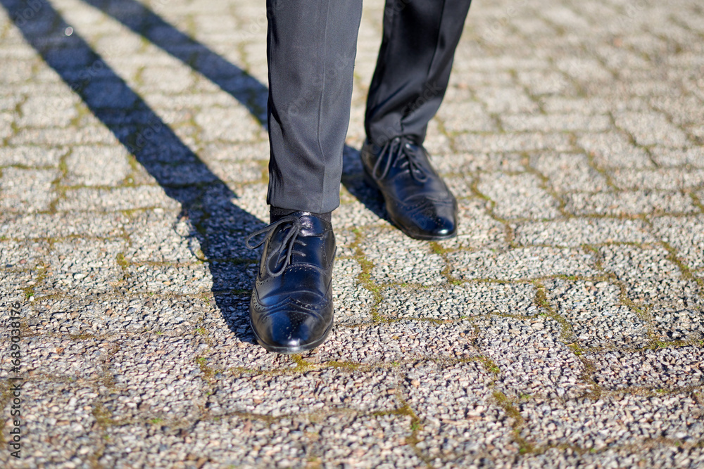 Close-up of man's shoes, dressed formally, standing on pavement Close-up of man's shoes, dressed formally, standing on pavement