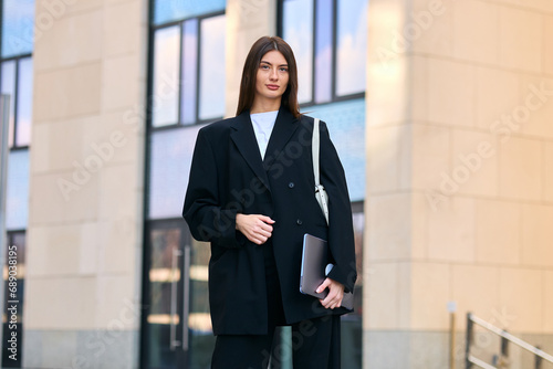Stylish woman businessman on the street. The beginning of the working day. A successful person