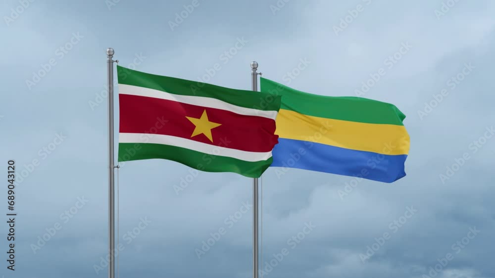 Gabon flag and Suriname flag waving together on cloudy sky, endless seamless loop, two country relations concept Gabon flag and Suriname flag waving together on cloudy sky, endless seamless loop, two country relations concept