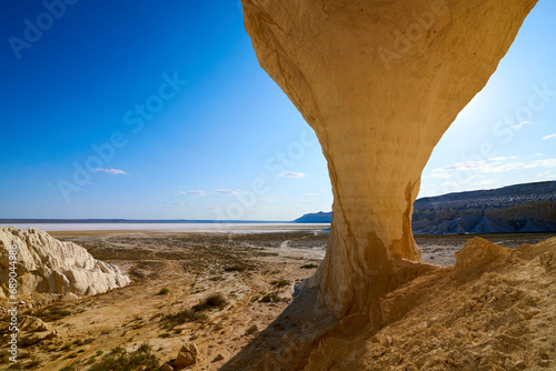  Natural arch on the Tuzbair salt marsh. Natural arch at Tuzbair is a natural formation carved by erosion.Salt marsh Tuzbair is one of the most famous attractions of the Mangystau region of Kazakhstan photo